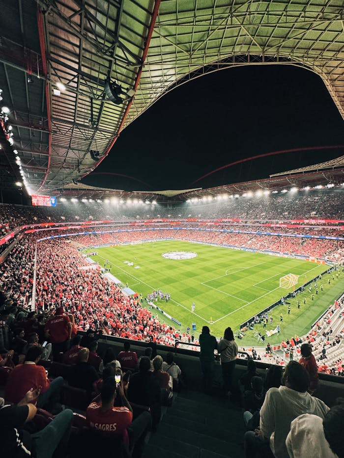 Home A thrilling football match at Estádio da Luz in Lisbon, capturing the vibrant atmosphere of the crowd and illuminated field.